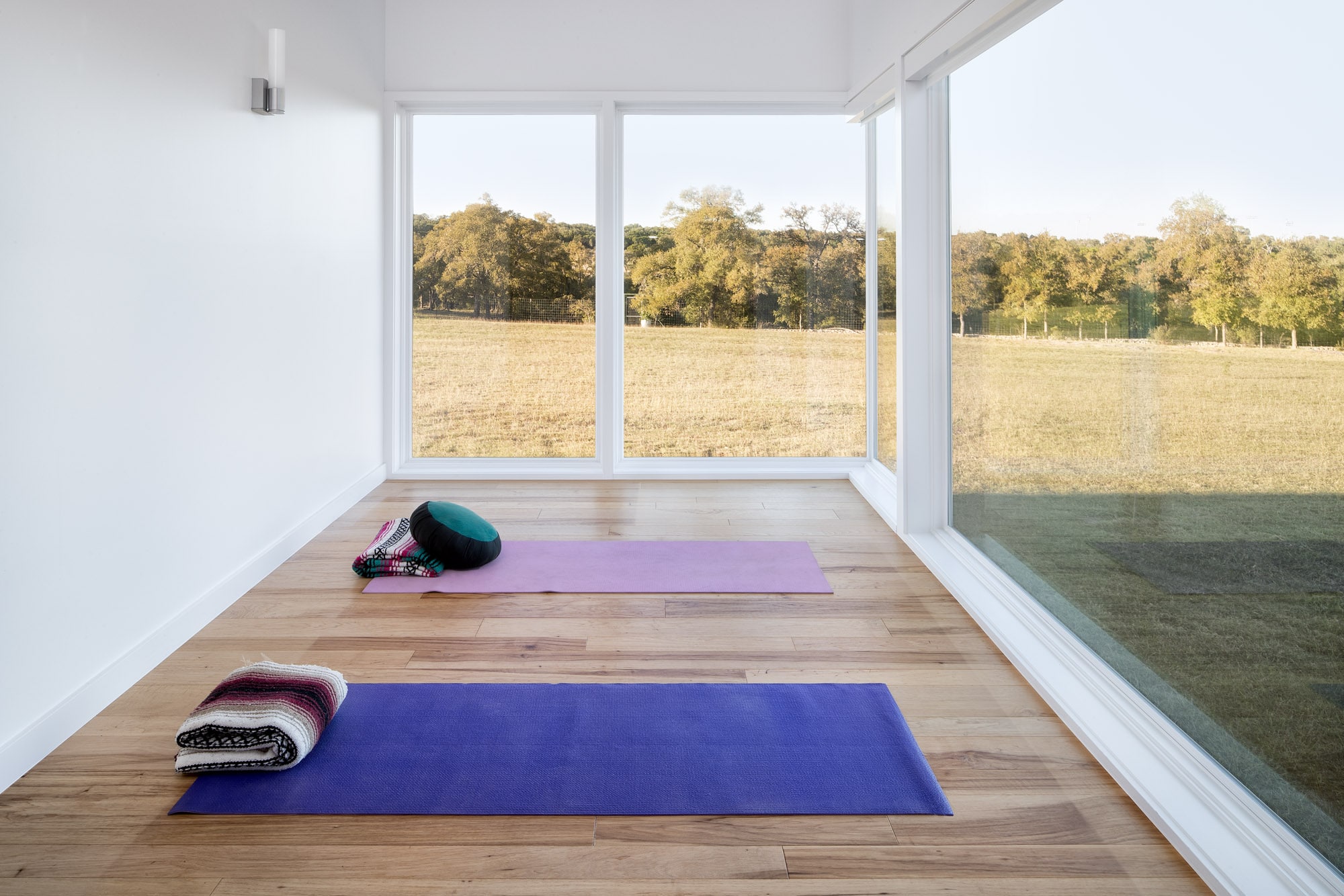 Yoga or meditation room with large windows Self-sustaining home in Wimberley Texas