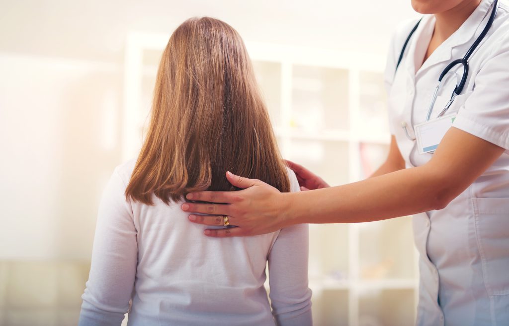 Chiropractor doing adjustment on female patient Chiropractor doing adjustment on female patient