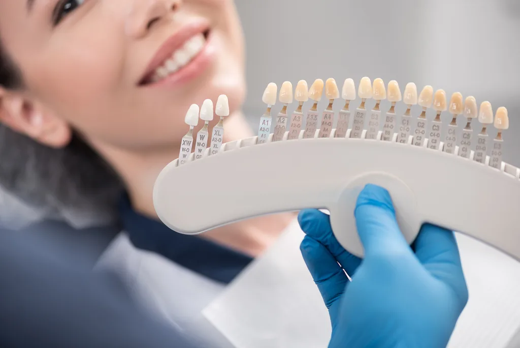 Odontologist arms showing teeth implants to patient; a gorgeous grin Tips for a Successful Smile Makeover