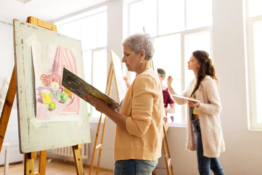 woman artist with easel painting at art school Enhance your mind Prioritizing Your Mental Health wellness