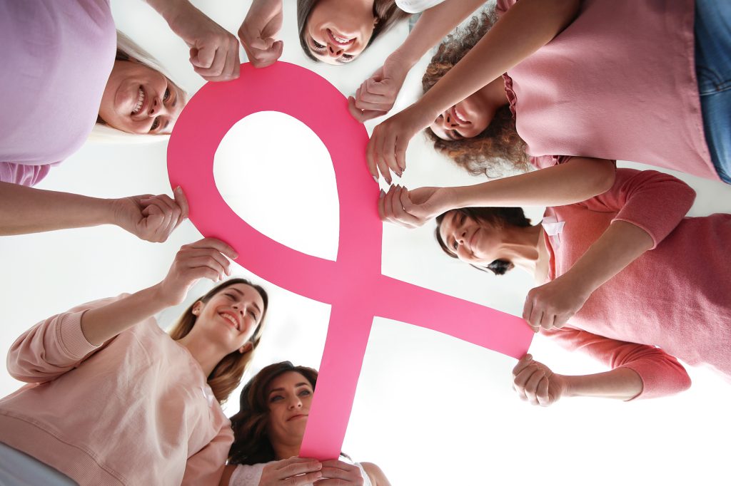 Women holding pink paper ribbon, bottom view Breast cancer awar Women holding pink paper ribbon, bottom view Breast cancer awar