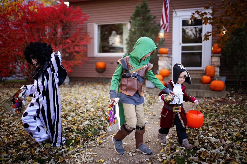 Young Kids Dressed in Costumes Trick or Treating on Halloween in America