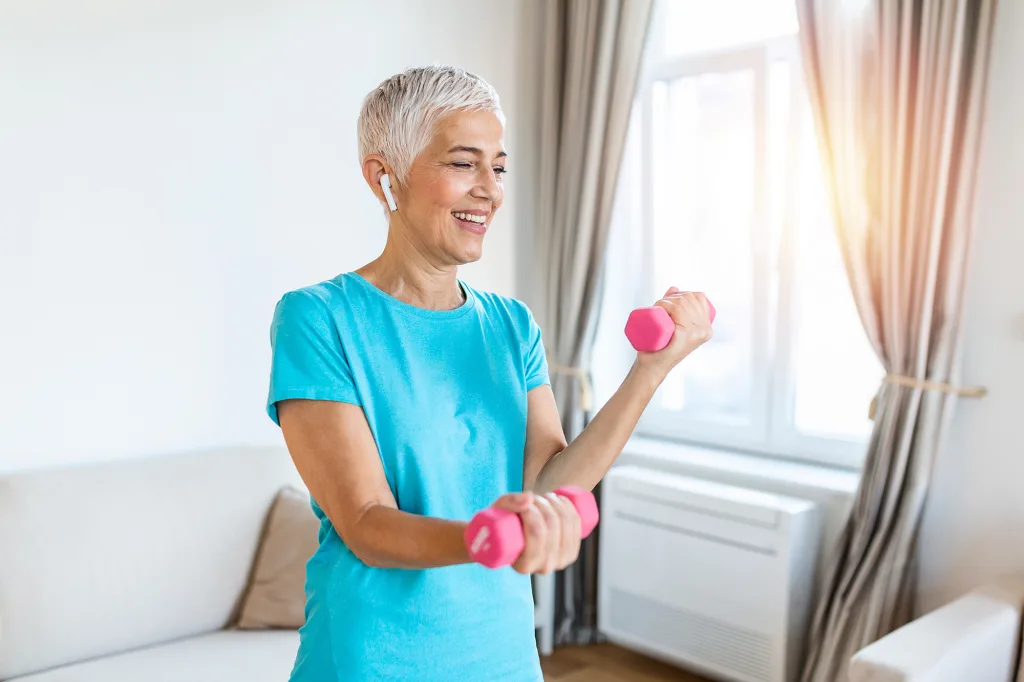 Senior woman exercise with dumbbells at home happy mature woman doing arm workout using dumbbells Elderly woman prefers healthy lifestyle How to Combat Age-Related Muscle Loss; Senior woman exercise with dumbbells at home happy mature woman doing arm workout using dumbbells Elderly woman prefers healthy lifestyle