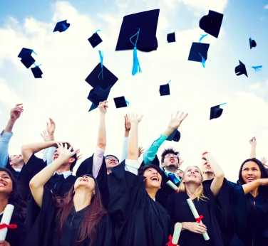 Graduating students throwing hats in the air; Get Ready for Graduation: Party Ideas, Gifts, and More