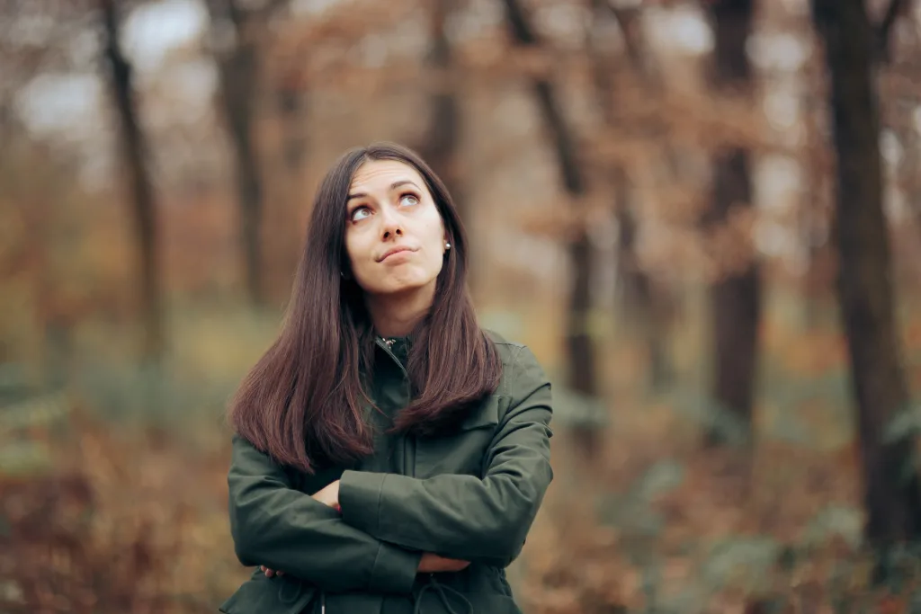 Bored Woman Looking at Foliage in Autumn Season Bored Woman Looking at Foliage in Autumn Season