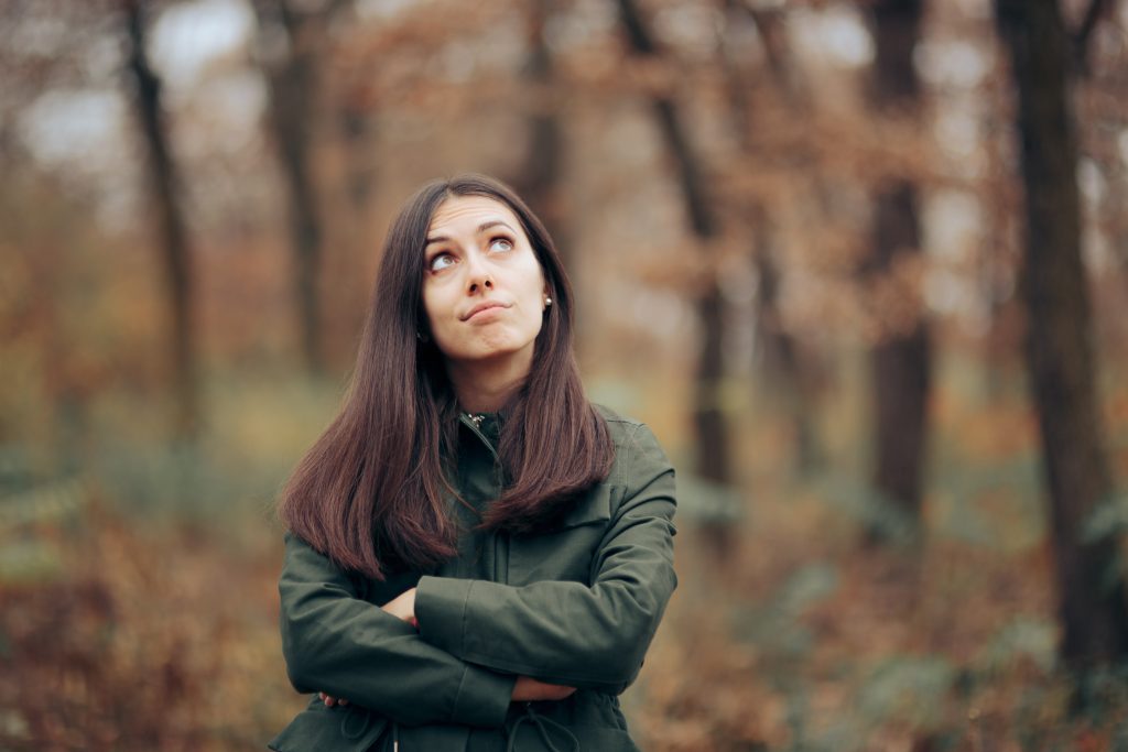 Bored Woman Looking at Foliage in Autumn Season