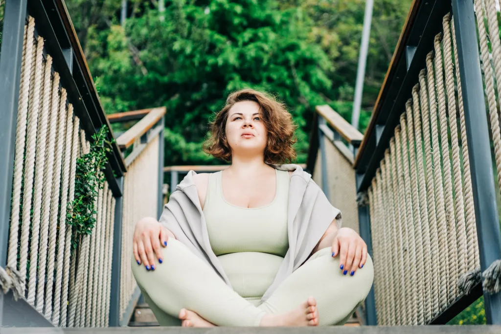 Plus size woman doing yoga and meditation