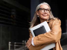 portrait of an elderly businesswoman with a laptop in glasses outside the office, strong and independent woman concept Why Women are More Prone to Vision Problems than Men
