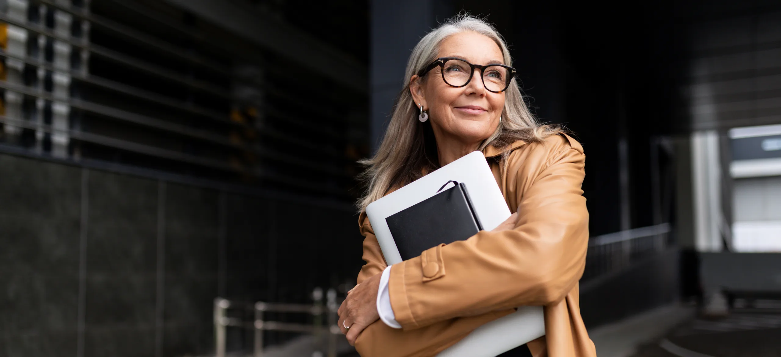 portrait of an elderly businesswoman with a laptop in glasses outside the office, strong and independent woman concept Why Women are More Prone to Vision Problems than Men
