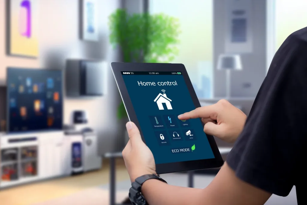 hands holding smart digital tablet with app smart home on blurr