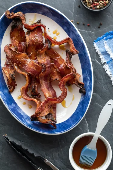 A platter filled with crispy maple pepper bacon, ready for eating