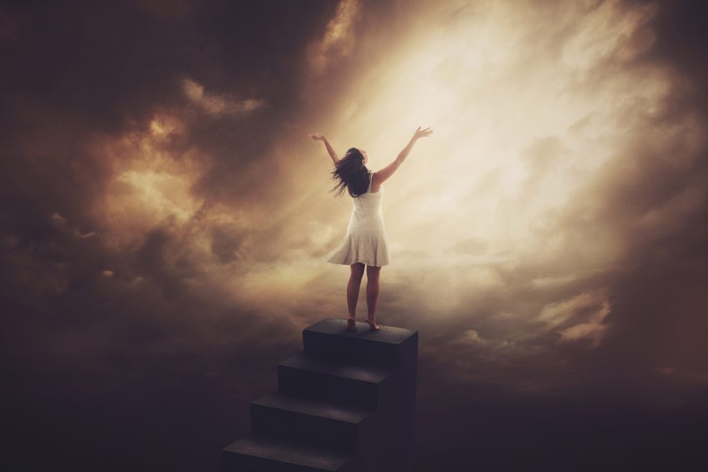 A woman climbs to the top of a tall staircase to worship.