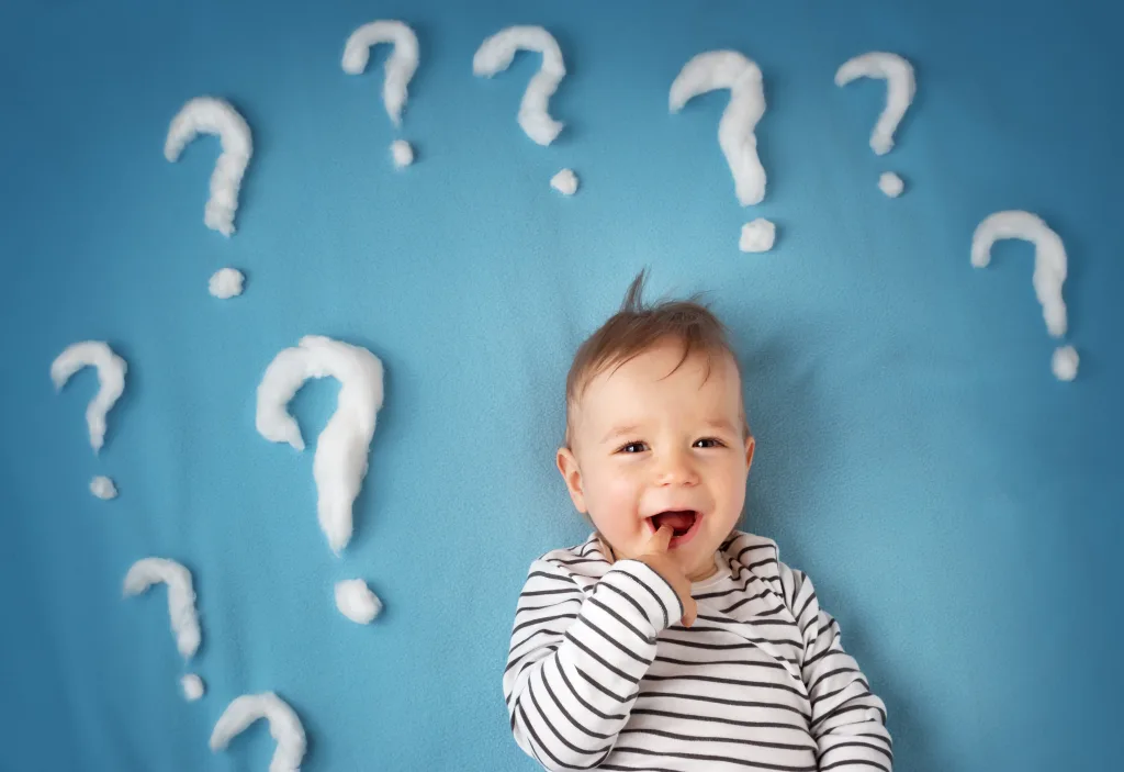 little boy with lots of question marks