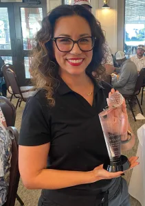 Angela Garza displaying award