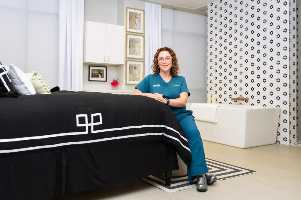 Birthpointe Traci Santangelo, APRN, CNM leans against birthing bed