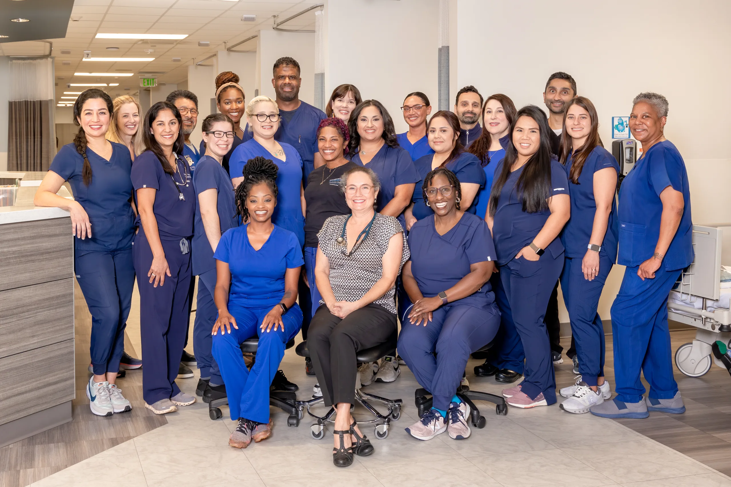 Digestive Health Center of Dallas staff poses for group photo wearing blue scrubs