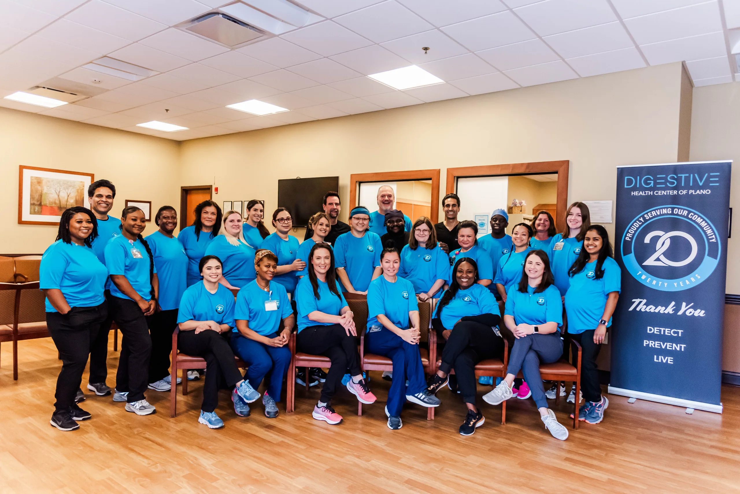 Staff of Digestive Health Center of Plano wearing blue shirts posing for group photo