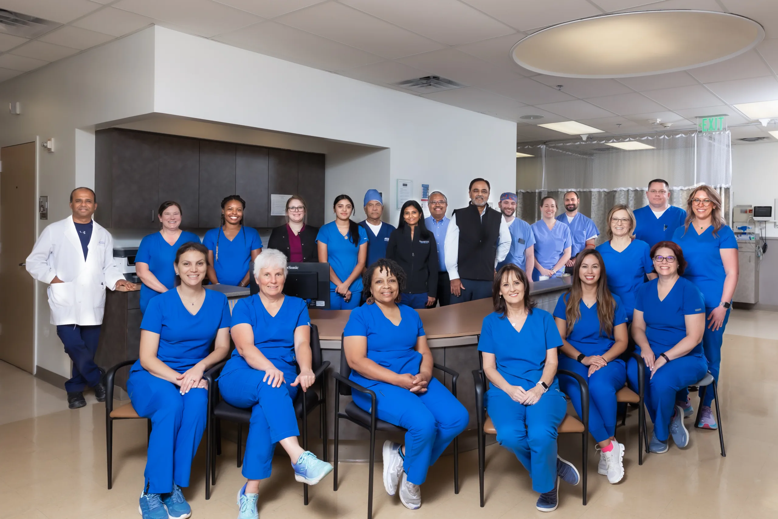 Digestive Health Center of North Richland Hills staff poses in blue scrubs for a group photo