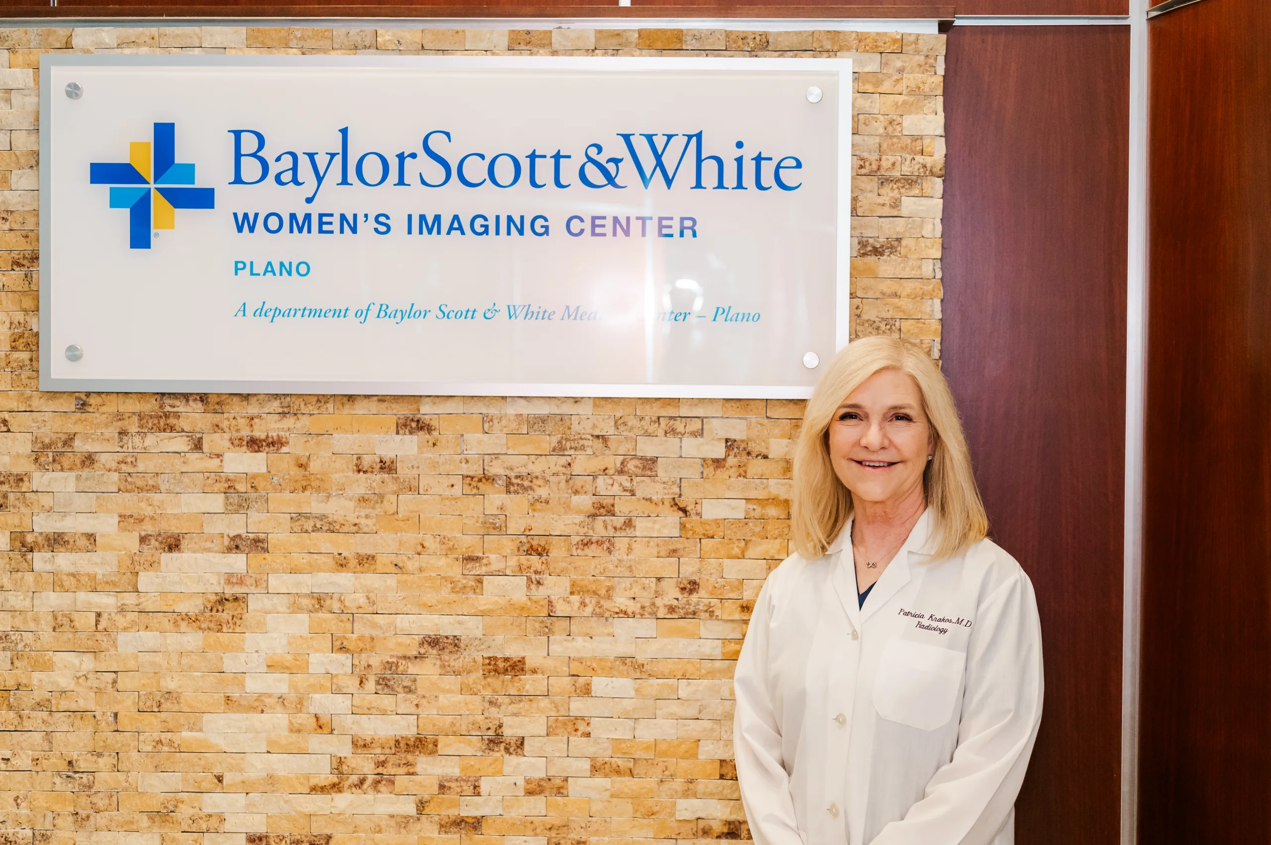Dr Krakos stands in front of bsw sign