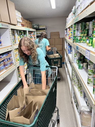 NCL Volunteers pack bags of food for food distibution