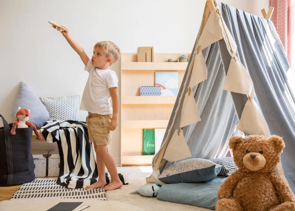 Teddy bear on the floor of stylish single child playroom with tent Make Unused Rooms Functional Again
enhanced environment