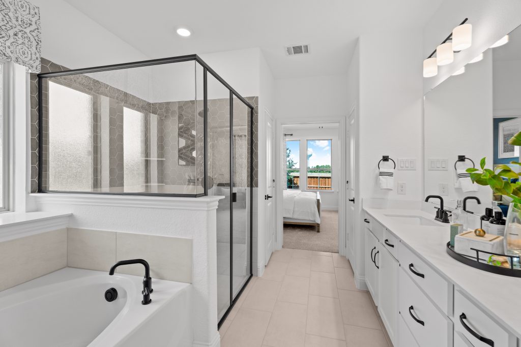 A white bathroom with a walk in shower and tub.