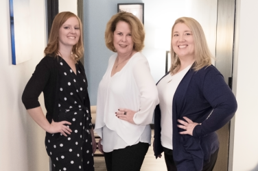 photo of three women in business casual clothes