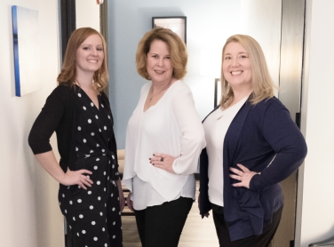 photo of three women in business casual clothes